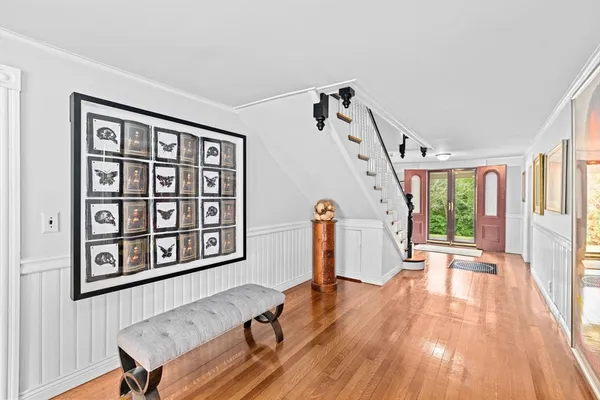 a view of a livingroom with wooden floor and furniture