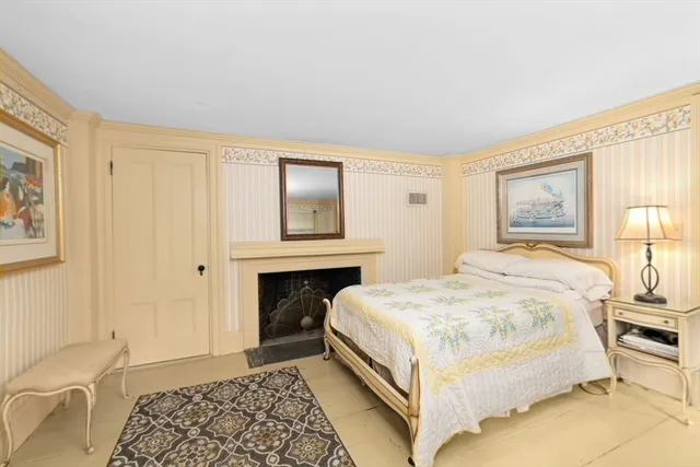 a bed room with a bed and chair