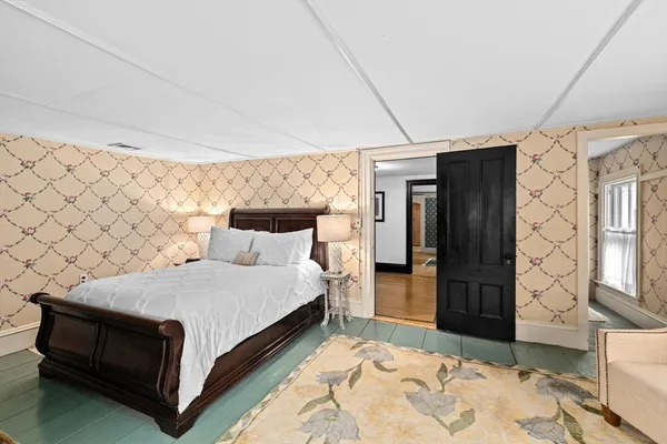 a bed room with a bed and a chair