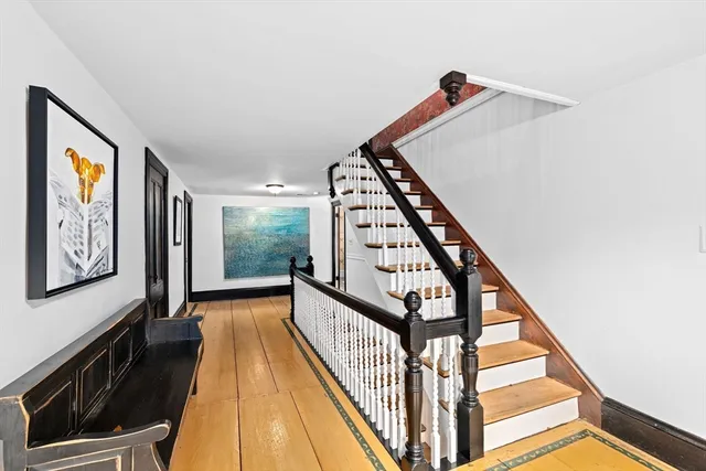 a view of an entryway with wooden floor
