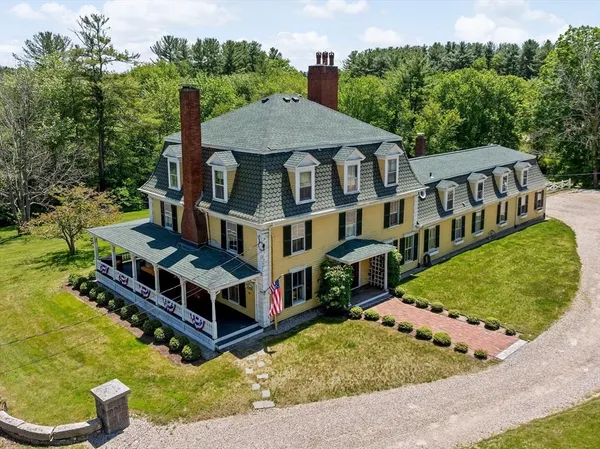 an aerial view of a house with a yard table and chairs