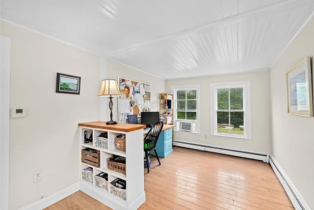 a view of a workspace with furniture and a window