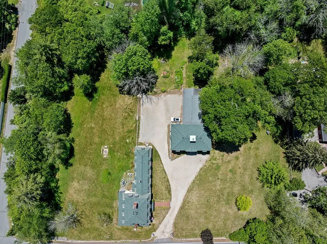 an aerial view of a house with a yard