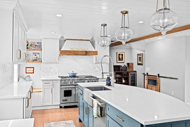 a kitchen with stainless steel appliances granite countertop a stove and a sink