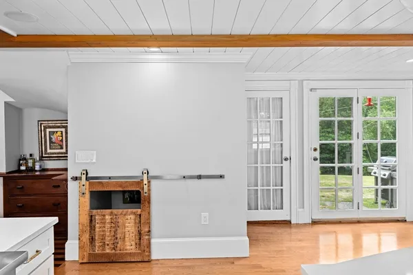 a view of a bedroom with wooden floor and entryway