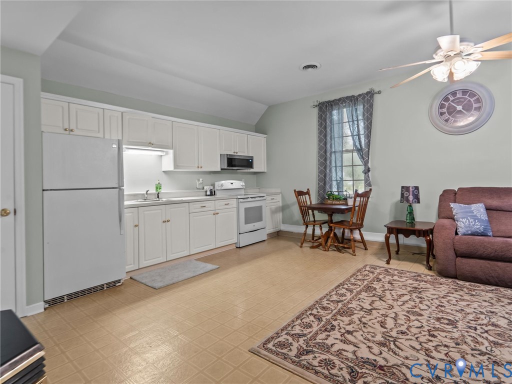 3420 State Rte 656 Powhatan, VA 23139 - Photo 27 of 37 a living room with furniture a dining table and appliances