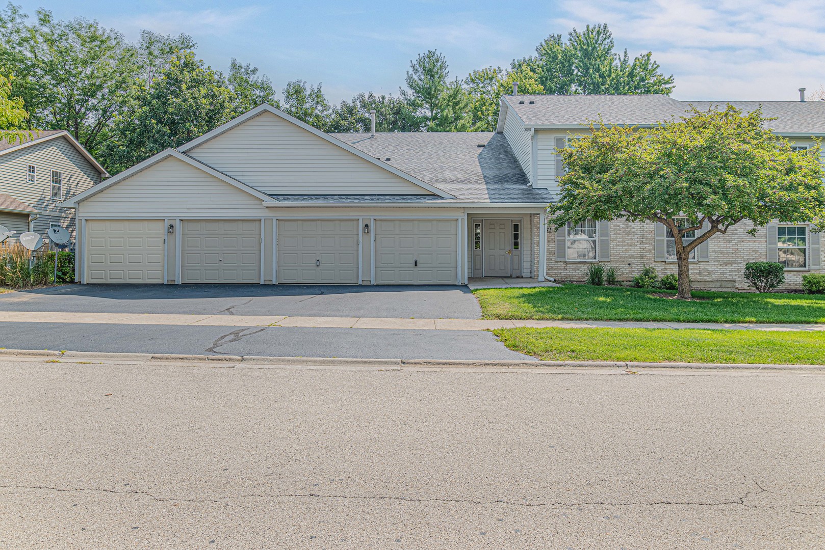 a view of a house with a yard and large tree
