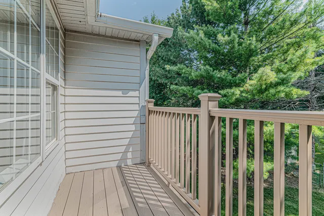 a view of a balcony with wooden floor