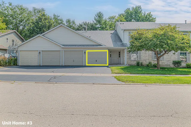 a view of a house with a yard and large tree