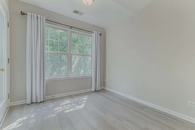 a view of room with window and hardwood floor