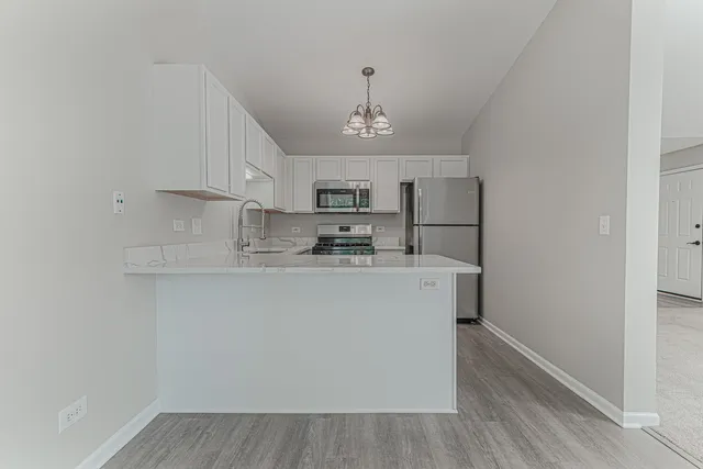a utility room with cabinets washer and dryer