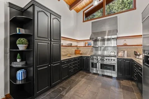 a kitchen with stainless steel appliances granite countertop a refrigerator and a stove