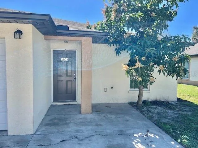 a view of a house with a tree