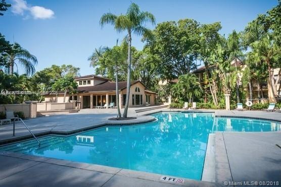 4541 West McNab Road, Unit 16 Pompano Beach, FL 33069 - Photo 18 of 23 front view of a house with a yard