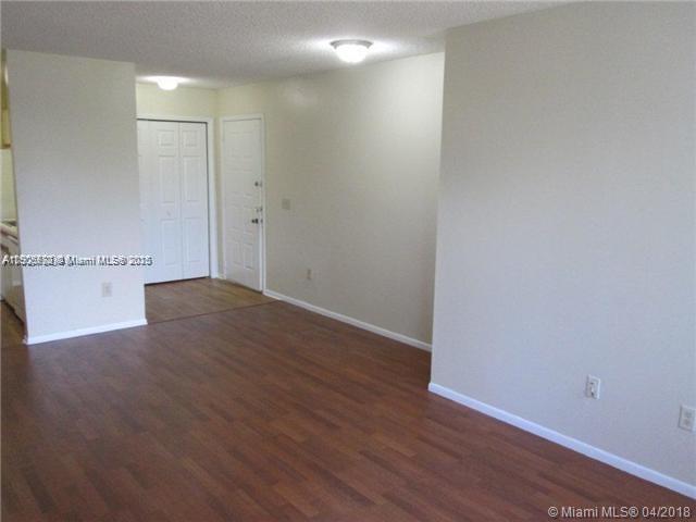 4541 West McNab Road, Unit 16 Pompano Beach, FL 33069 - Photo 2 of 23 a view of a room with wooden floor