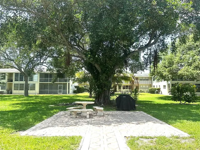 a living room with a large window and a fireplace
