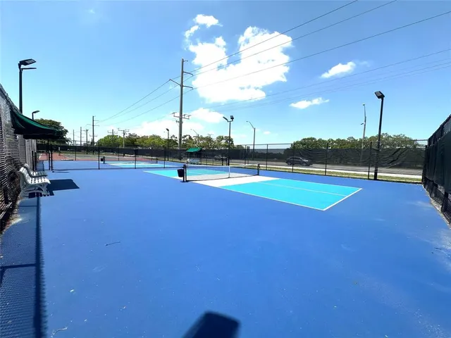 a living room with furniture and a dining table with kitchen view
