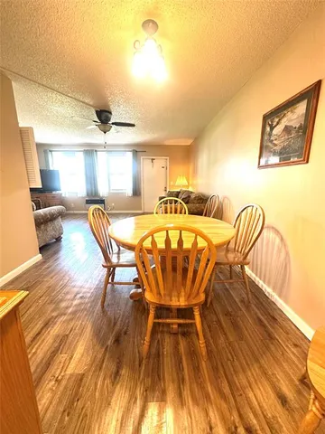 a dining room with furniture and wooden floor