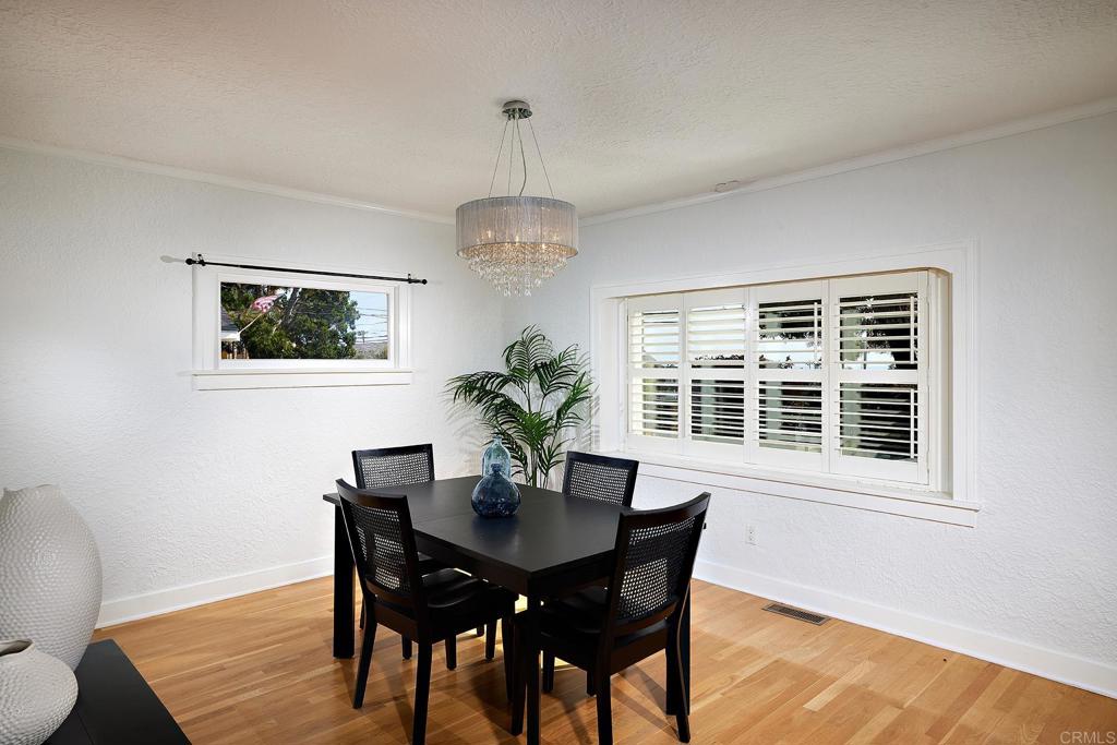 3252 Highland Drive Carlsbad, CA 92008 - Photo 17 of 55 a dining room with furniture a window and wooden floor