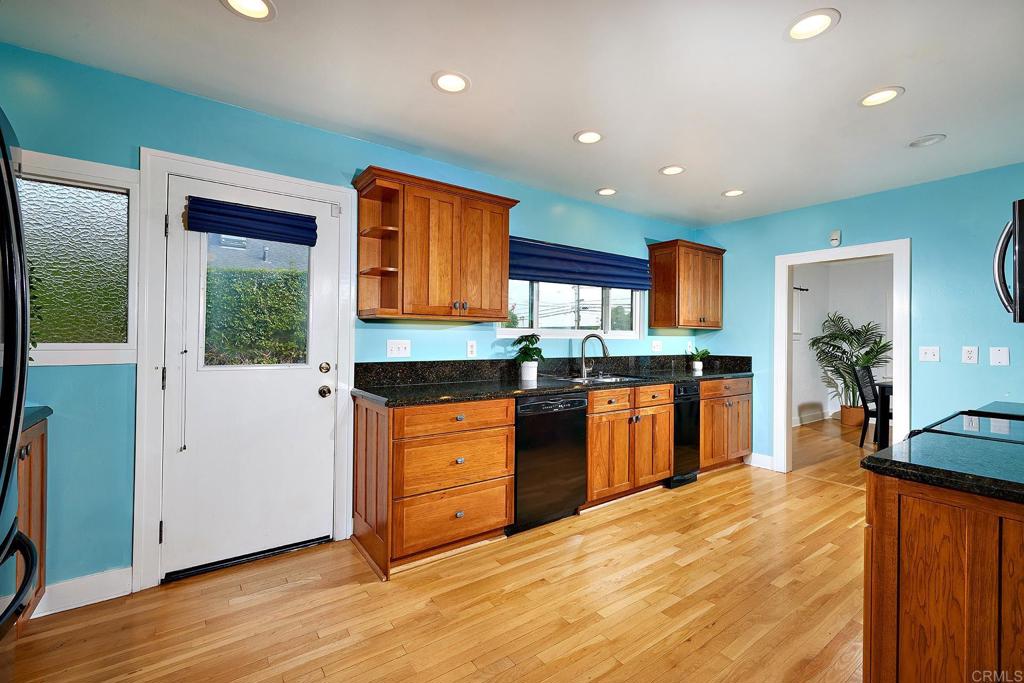 3252 Highland Drive Carlsbad, CA 92008 - Photo 19 of 55 a kitchen with stainless steel appliances kitchen island granite countertop wooden cabinets a granite counter top and a stove