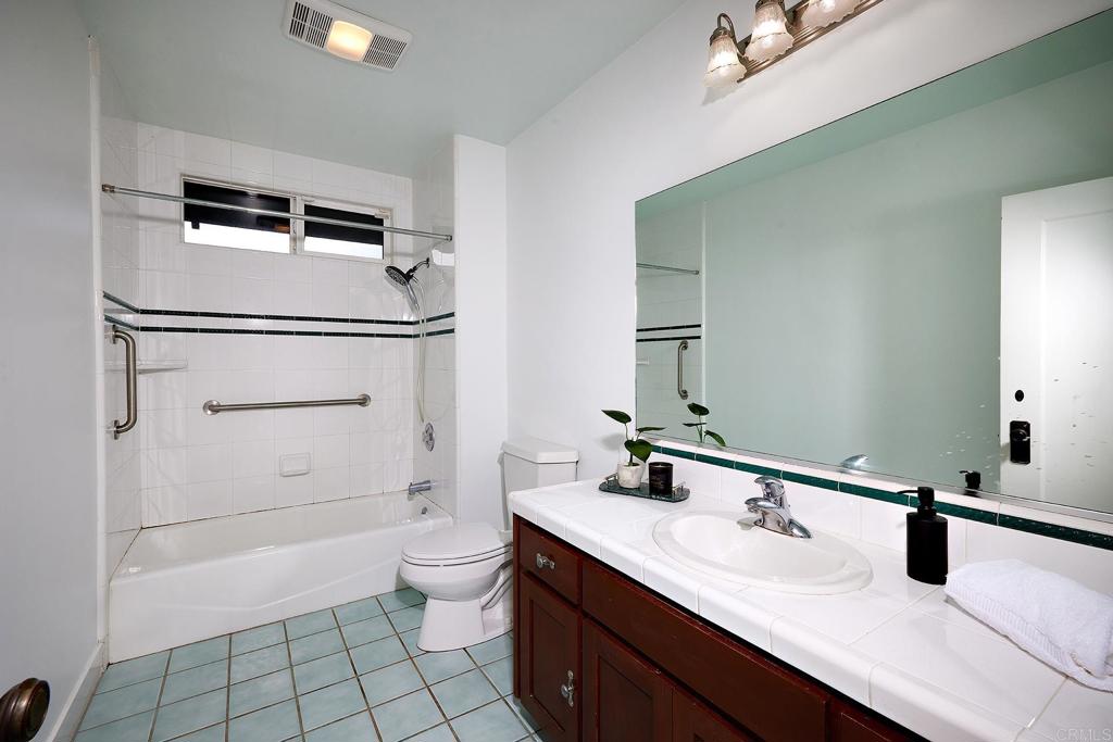 3252 Highland Drive Carlsbad, CA 92008 - Photo 25 of 55 a bathroom with a sink a toilet and a mirror