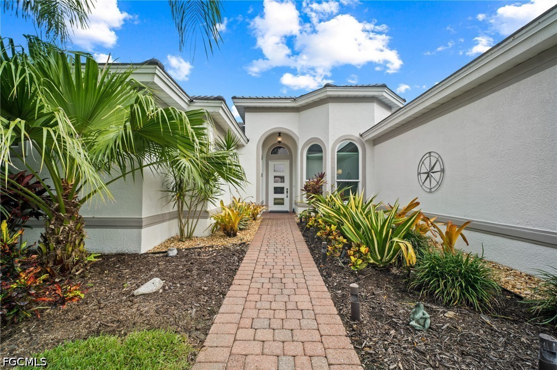 9042 Bronco Court Naples, FL 34113 - Photo 4 of 50 a view of entryway with garden