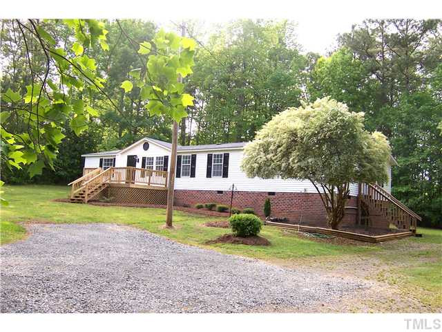 Another view of lovely landscaping and mature trees beyond. Exterior Front
