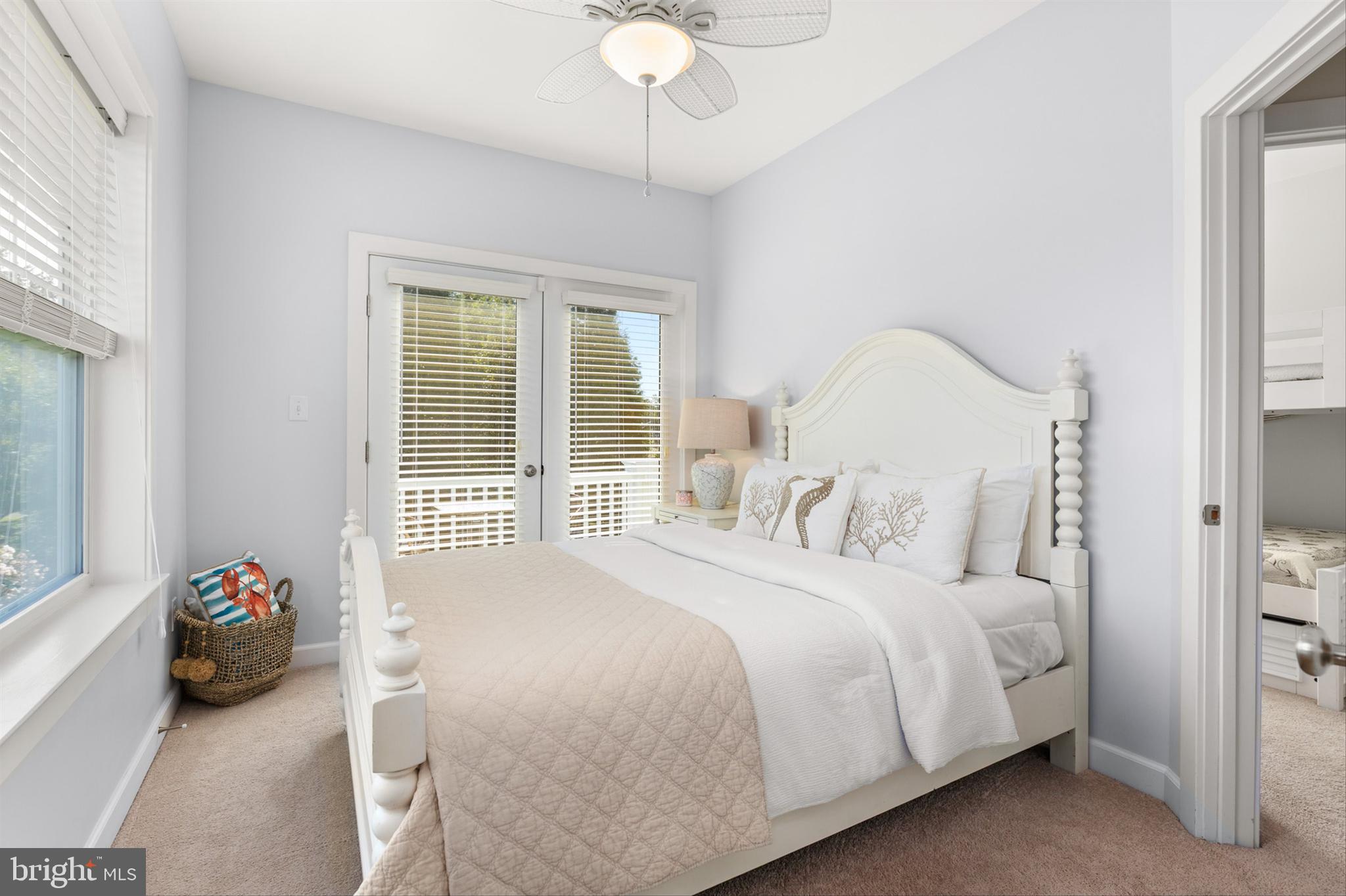 2 Smithfield Court, Unit 111 Ocean View, DE 19970 - Photo 22 of 32 a bedroom with a bed and a chandelier