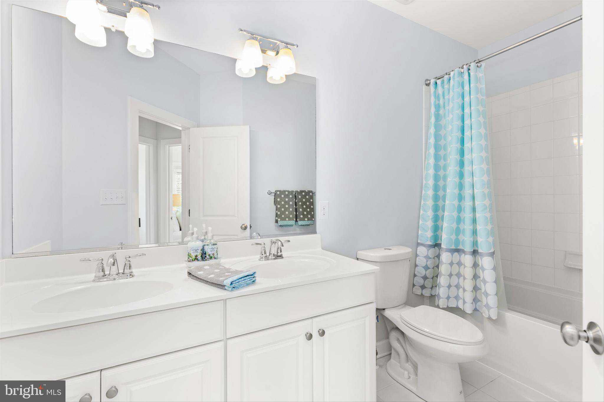 2 Smithfield Court, Unit 111 Ocean View, DE 19970 - Photo 28 of 32 a bathroom with a double vanity sink mirror and toilet