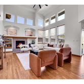 a living room with furniture a fireplace and a large window