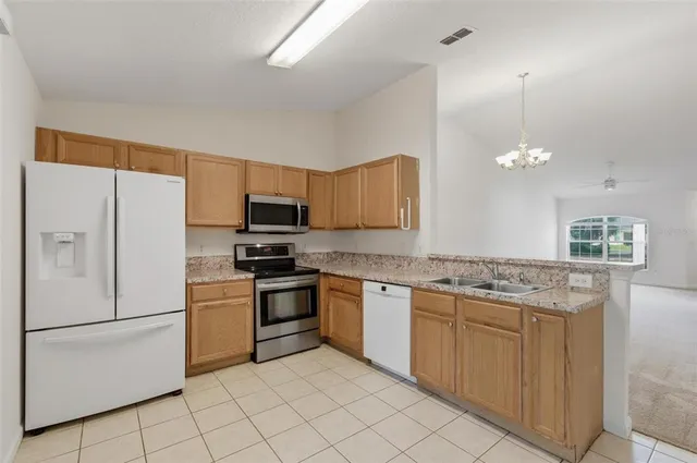 a white refrigerator freezer a stove sitting inside of a kitchen