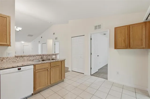 a kitchen with stainless steel appliances granite countertop a sink and cabinets