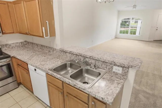 a kitchen with granite countertop a stove and a microwave