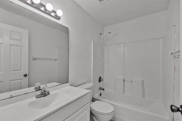 a bathroom with a bathtub and a toilet