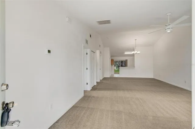 a view of a empty room with a kitchen