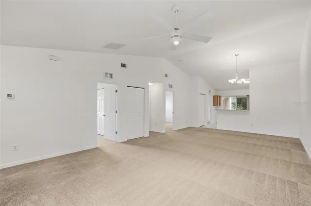 a view of a room with wooden floor and chandelier