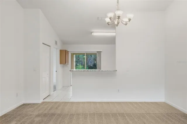 en empty room with windows and ceiling fan