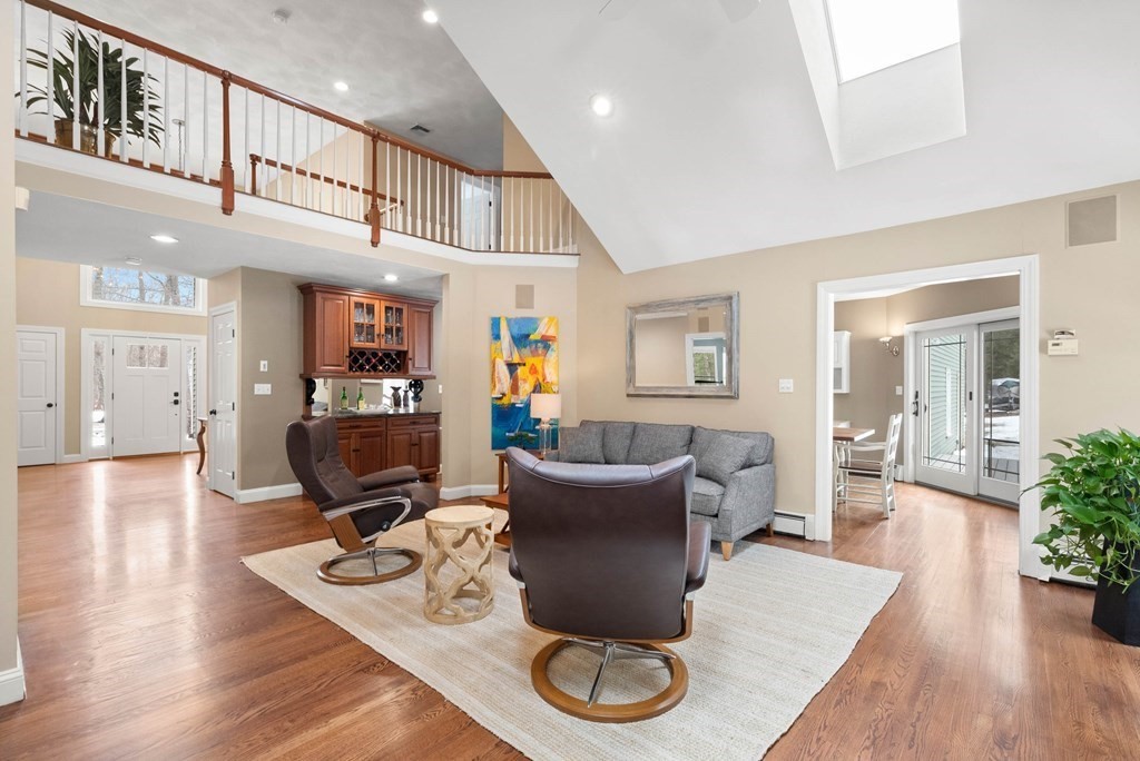9 Powder House Lane Boxford, MA 01921 - Photo 15 of 42 a living room with furniture a dining table and kitchen view