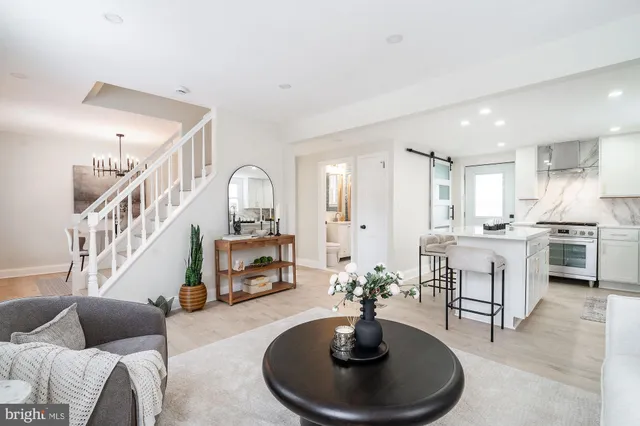 a living room with furniture and a dining table