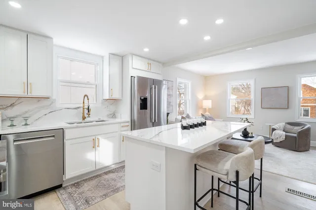 a kitchen with appliances a sink and cabinets