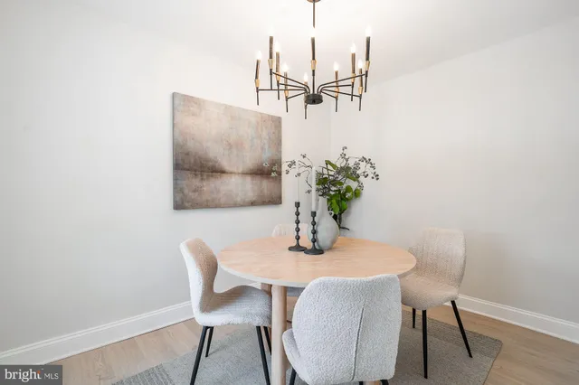 a dining room with furniture and wooden floor