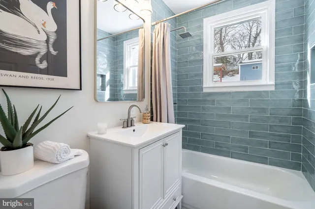 a bathroom with a sink toilet and tub
