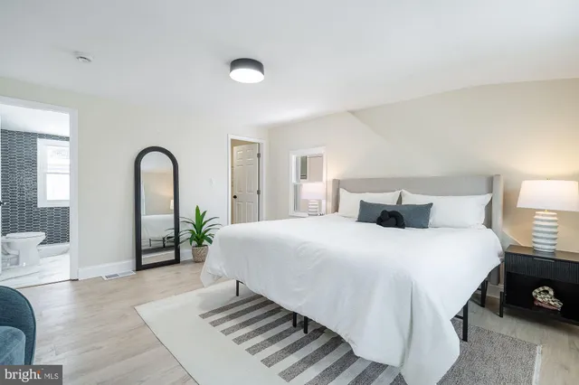 a bedroom with bed and a couch