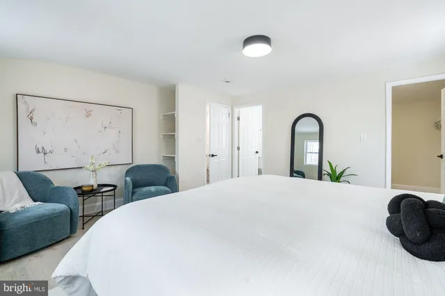 a bedroom with a bed and chair