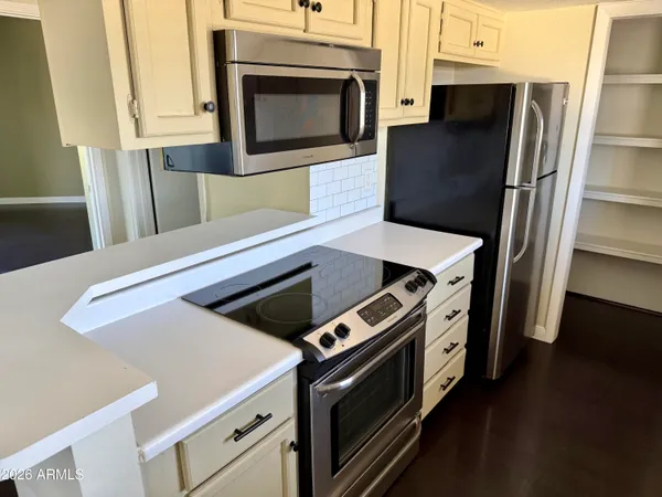 a stove top oven sitting inside of a kitchen