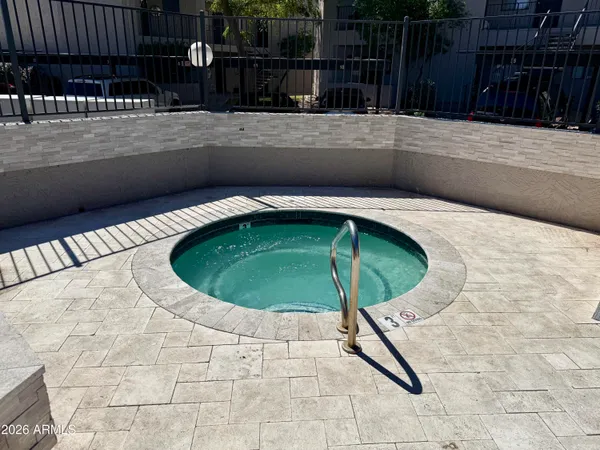 a small pool with a table and chair