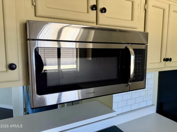 a kitchen with an oven and a refrigerator