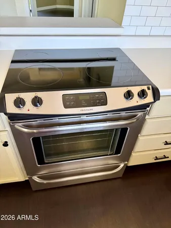 a stove top oven sitting inside of a kitchen