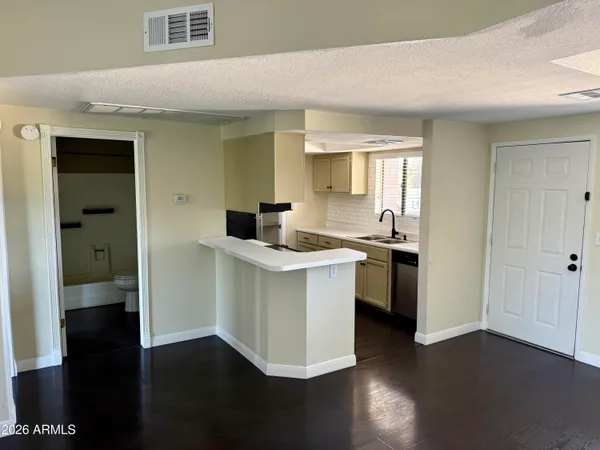 a kitchen with a sink cabinets stainless steel appliances and a window