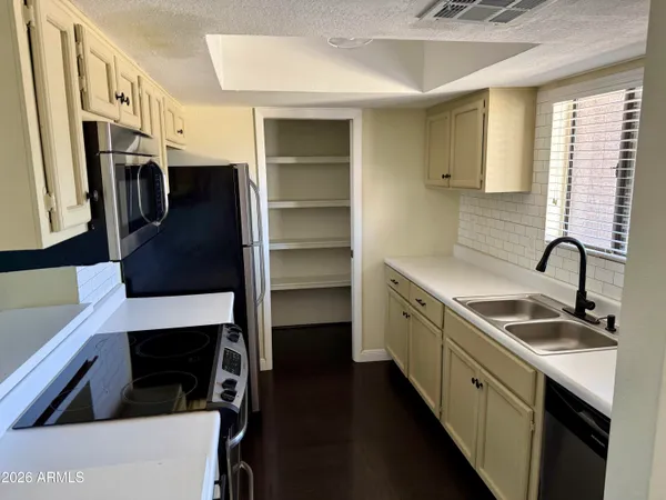 a kitchen with stainless steel appliances a sink stove and a refrigerator